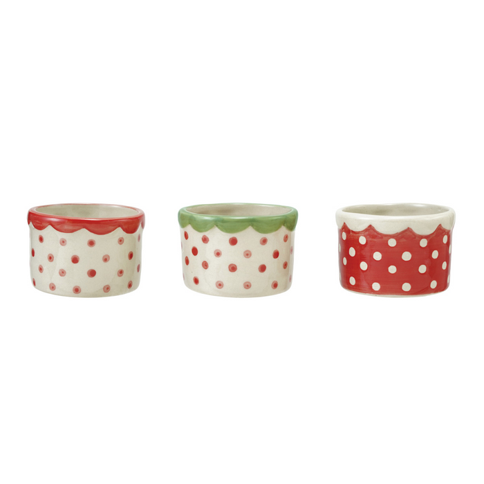 Three ceramic pots with red polka dot patterns on a white background