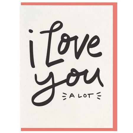 white card that reads "i love you a lot" with a peach colored envelope