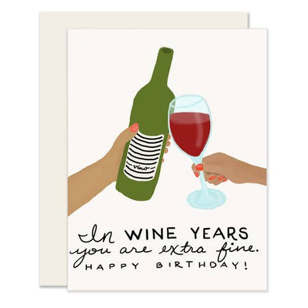 Greeting card with an illustration of a wine bottle and a glass of red wine, along with text that reads 'In wine years you are extra fine happy birthday!'.