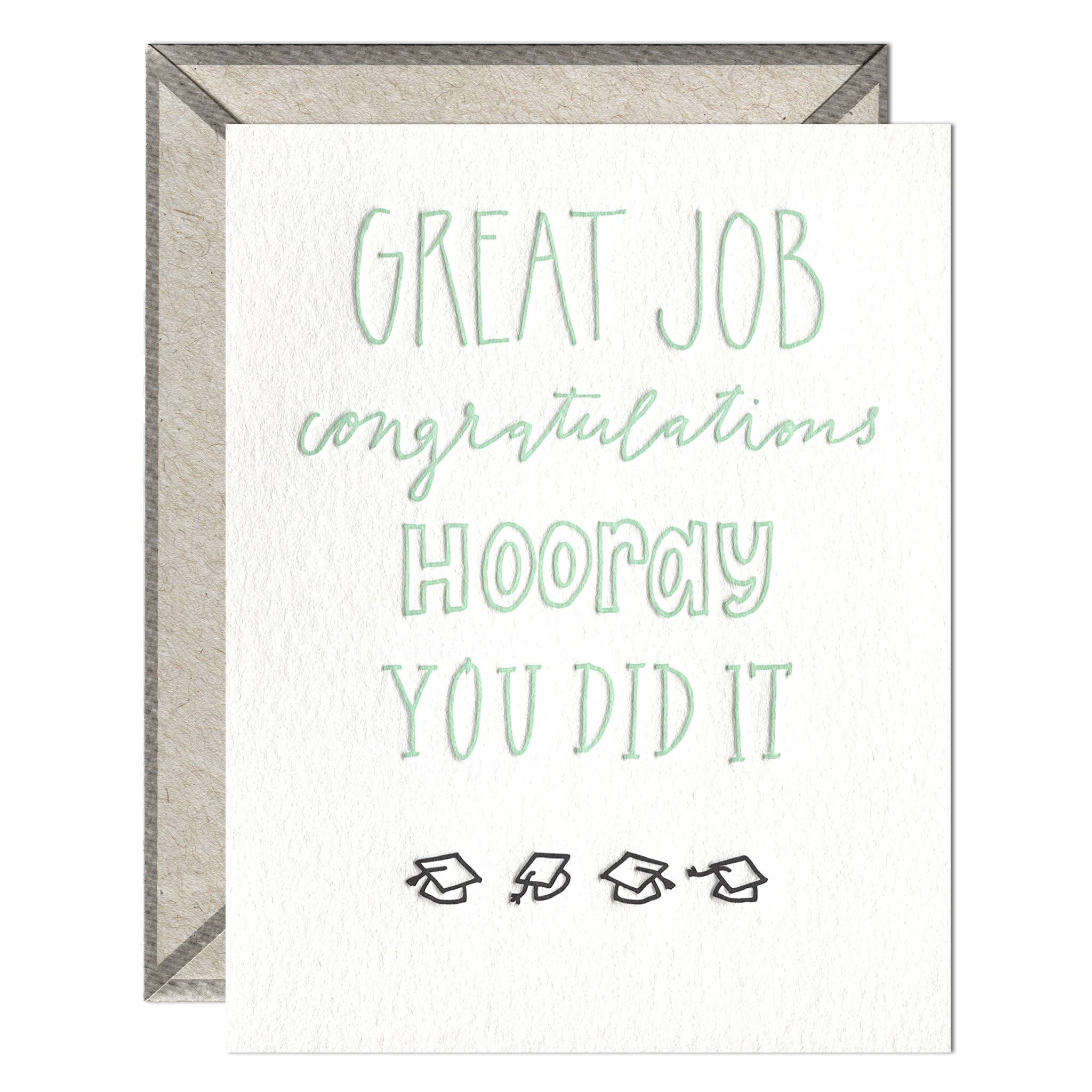letterpress card that reads "great job, congratulations, hooray, you did it" in green ink with grad caps below the words on a white background