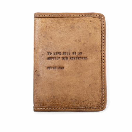 Leather passport cover with peter pan quote on a white background